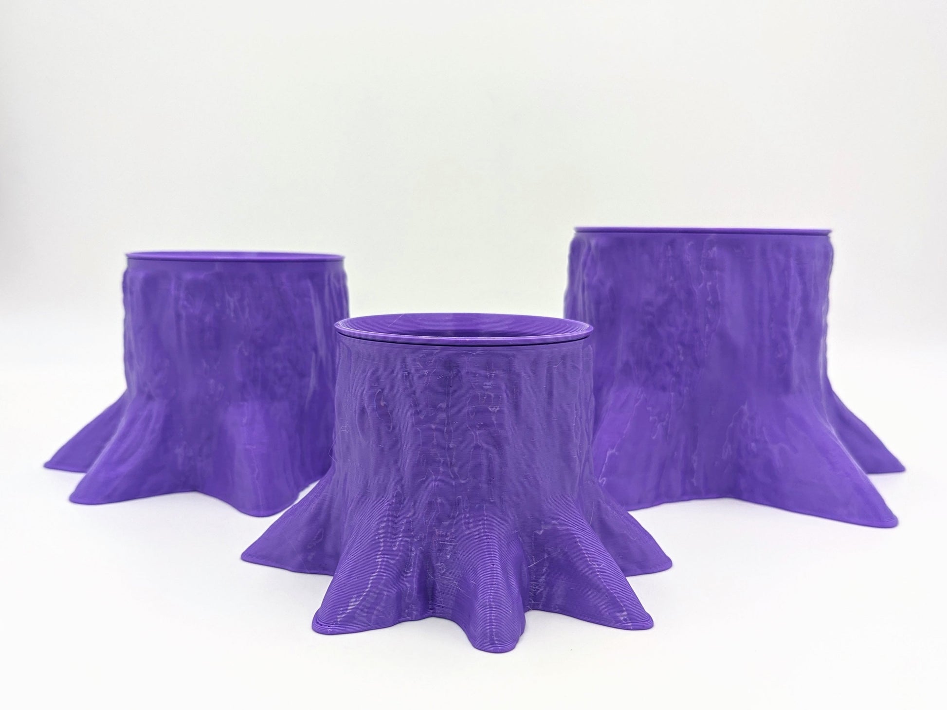 Funky, trunk-shaped planter in purple, recycled plastic.