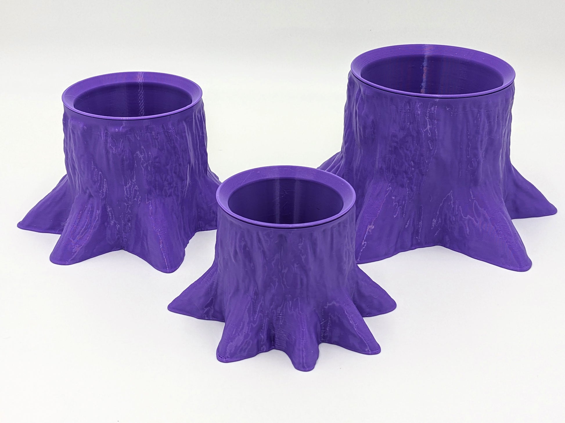 Funky, trunk-shaped planter in purple, recycled plastic.