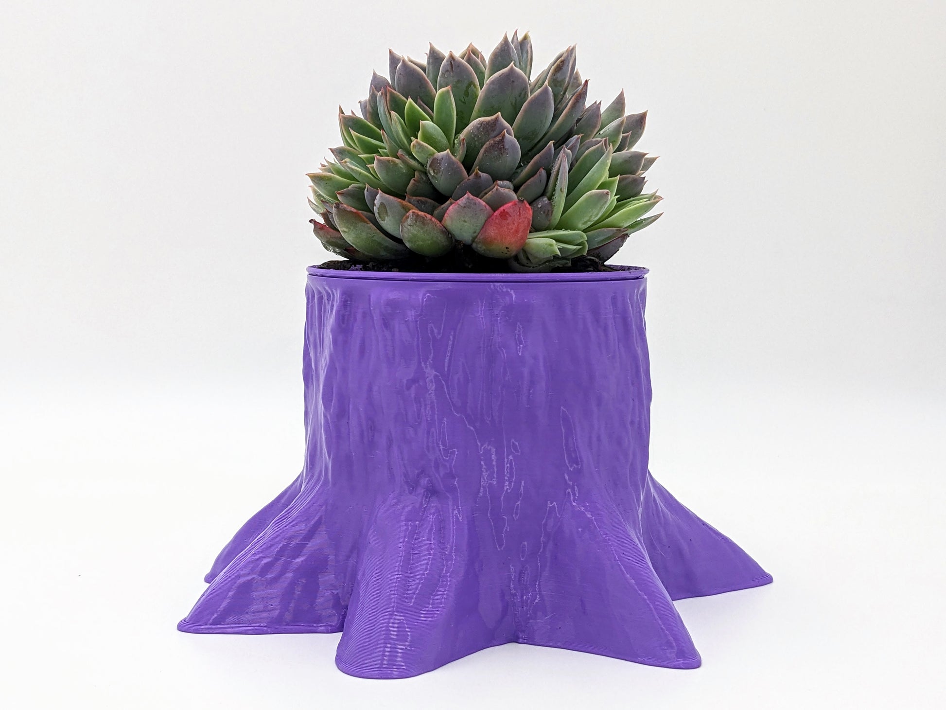 Funky, trunk-shaped planter in purple, recycled plastic.